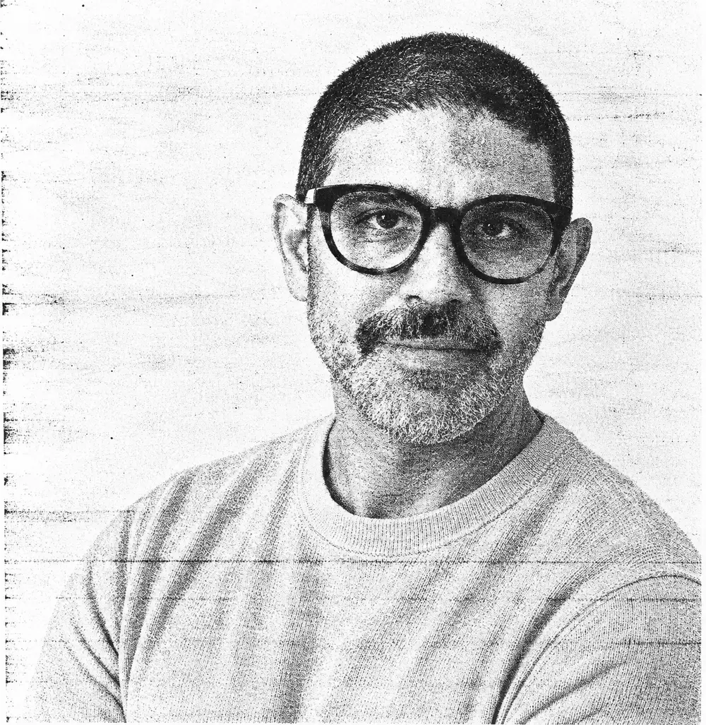 Portrait of Terry Mota in glasses, printed in a grainy photocopy style.
